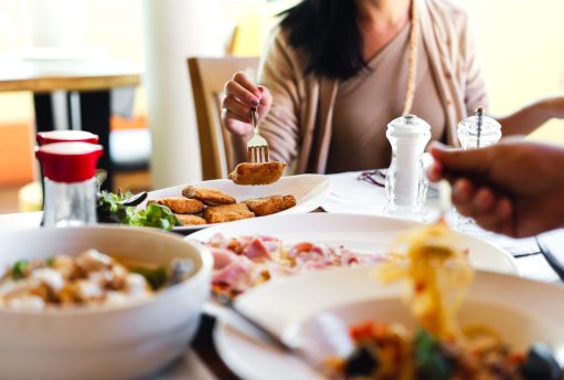 Italian food meal at restaurant with natural light. Focus on Carrozza deep fry mozzarella cheese sandwich traditional local recipe dish. People eating on blur background